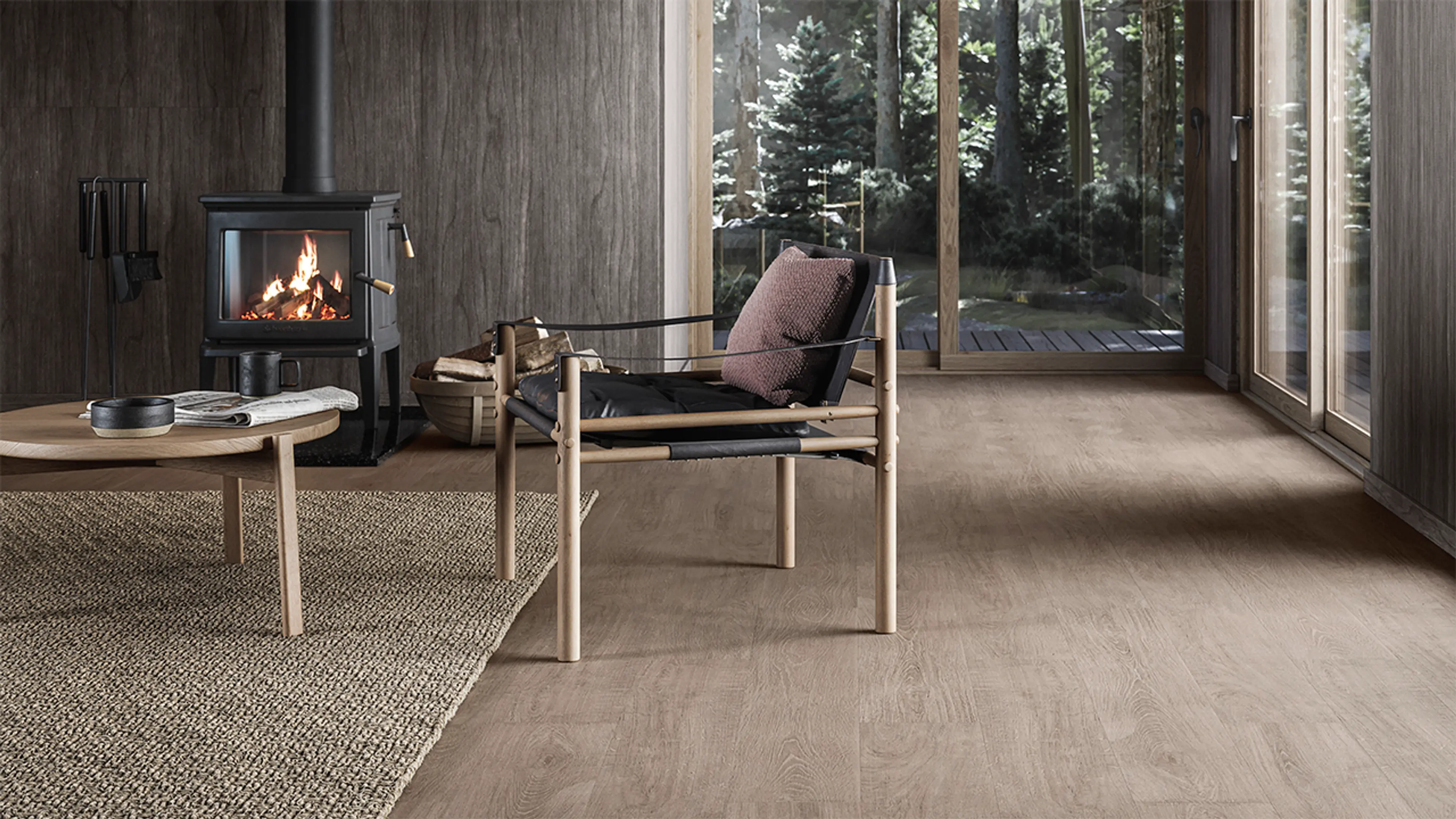 Moderne hytte med mørkt gulv og møbler i skandinavisk design.