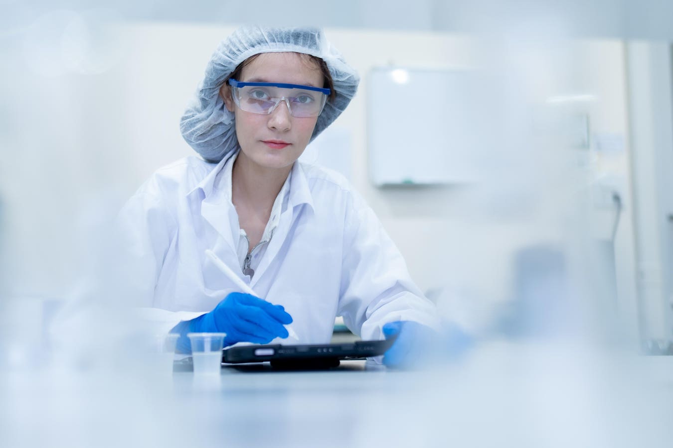 Pharma quality analyst performing digital validation in a GxP laboratory environment