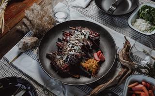 Coconut braised char siu venison ribs on set table