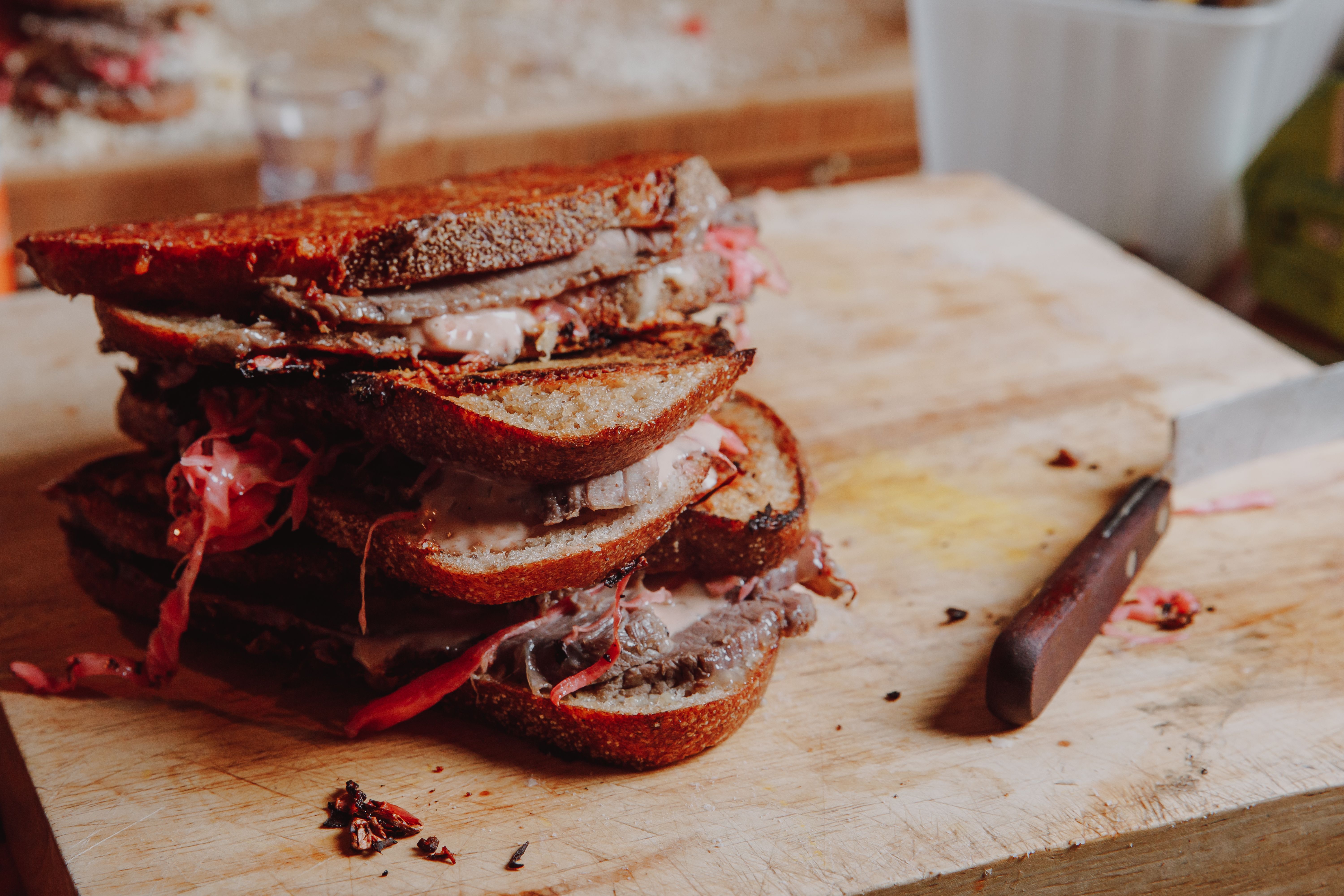 stacked sandwiches on chopping board