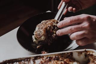 Wild Venison Cottage Pie being served onto a plate