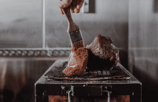 Wild Venison being cooked over a flame grill