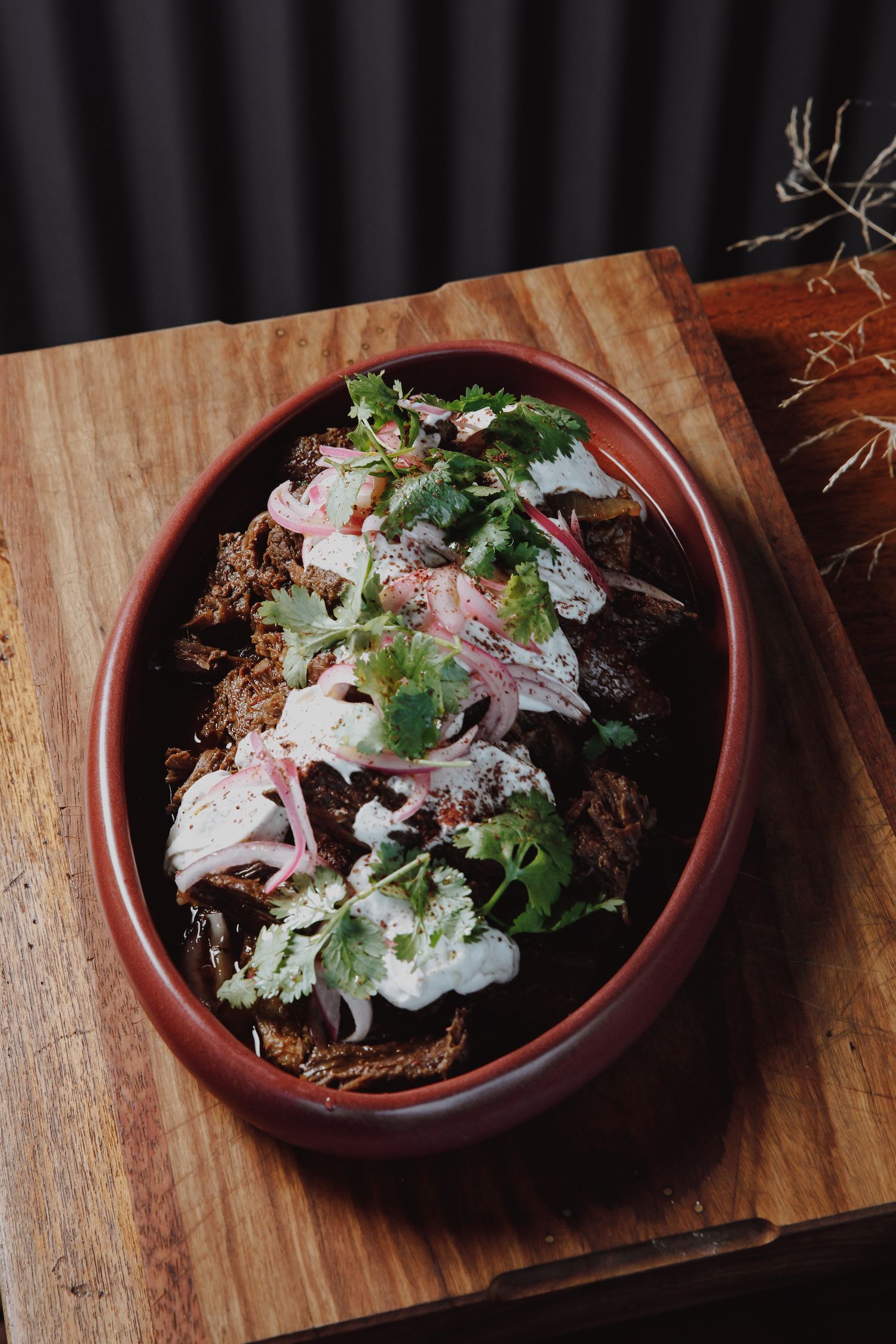 Venison Shwarma with yoghurt, onion and coriander served in a bowl 