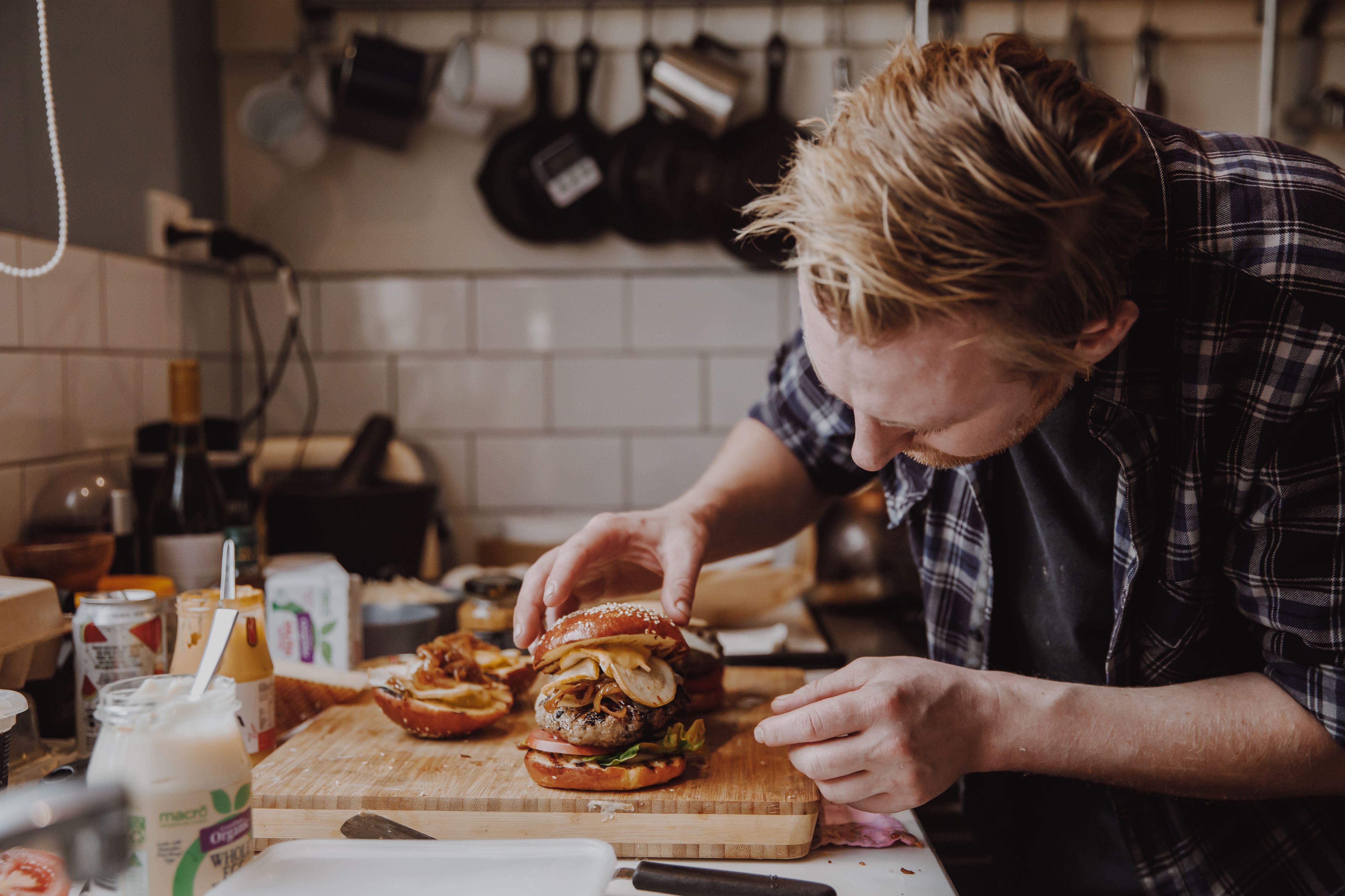 Preparing burger on kitchen counter