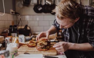 Preparing burger on kitchen counter