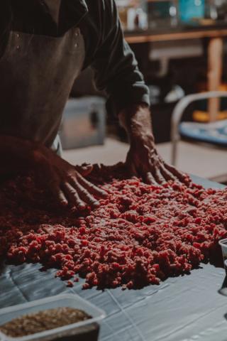 Jimmy Westley making Salami on a table
