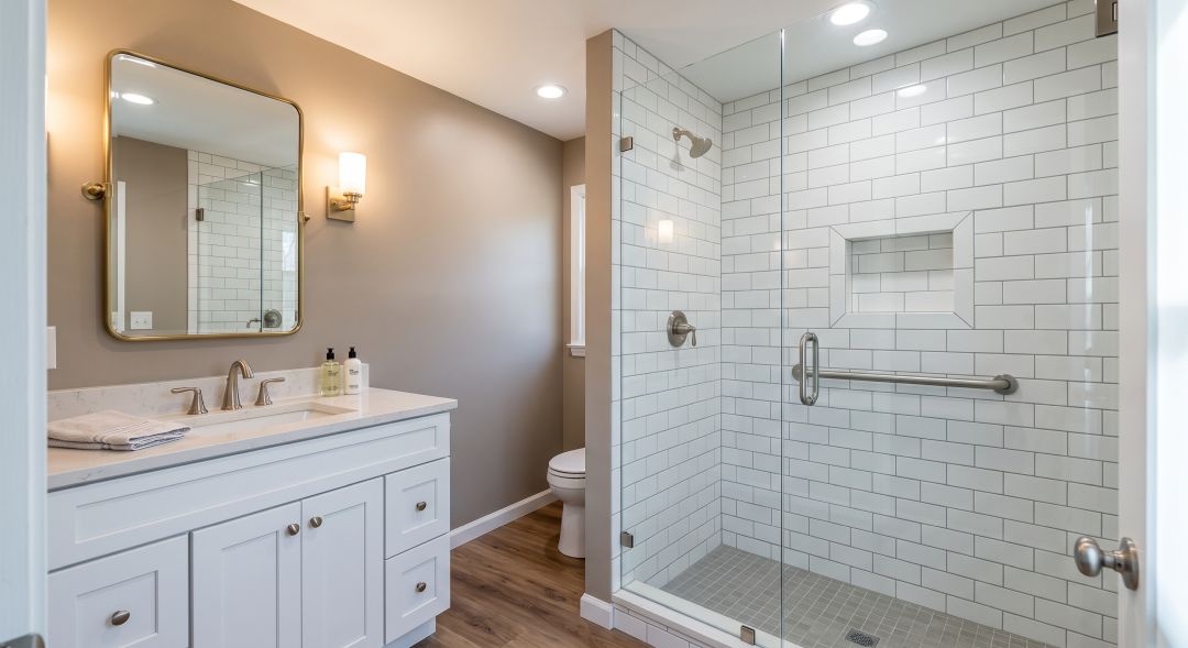 Tub to shower conversion with white cabinetry, walk-in shower and grab bar in an Agoura Hills CA bathroom