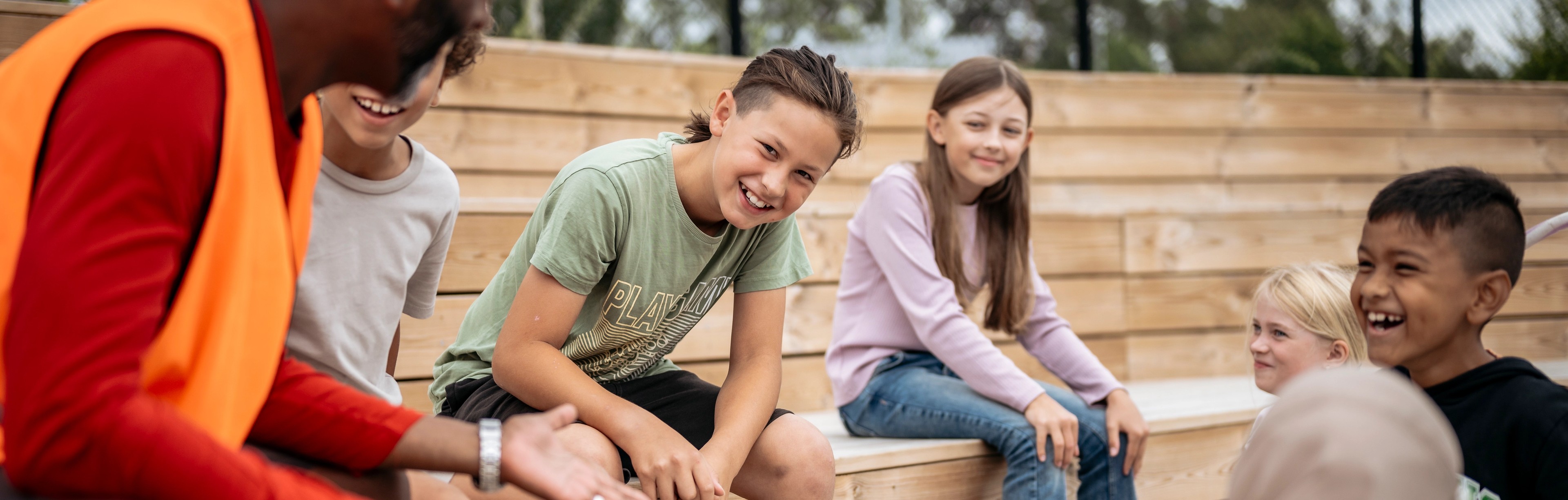 elever sitter i en gradäng utomhus