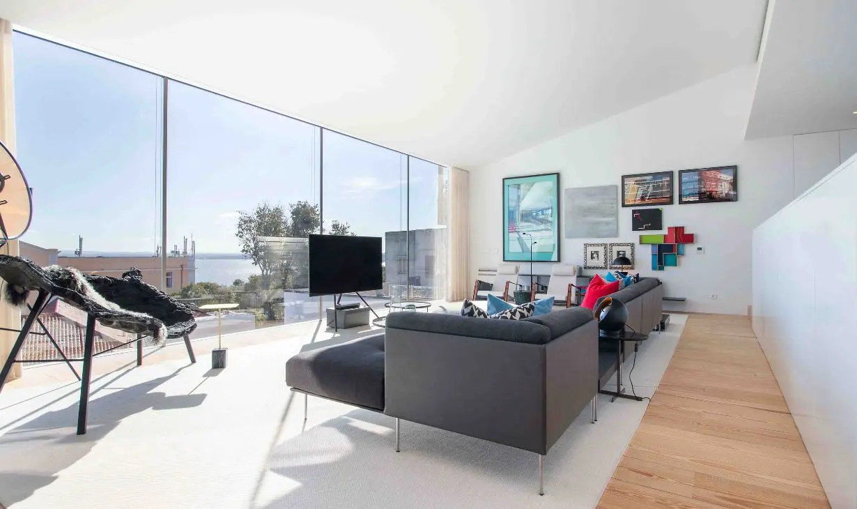 Luxury living room interior design project in Portugal by Atelier Renata Santos Machado, with panoramic sea views, contemporary furniture and natural light.