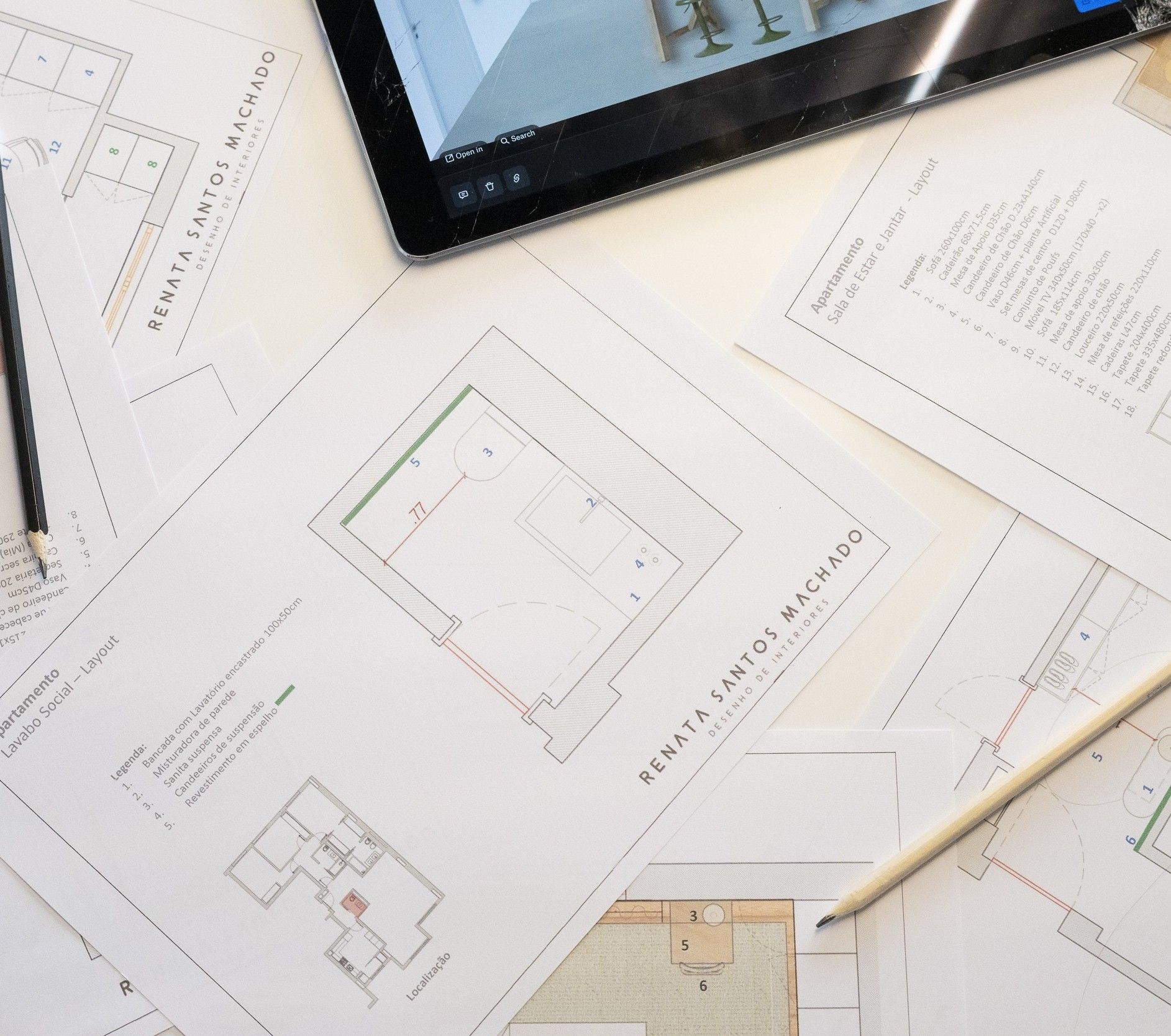 Technical floor plans and interior design project documents with tablet — design process at Atelier Renata Santos Machado, Lisbon
