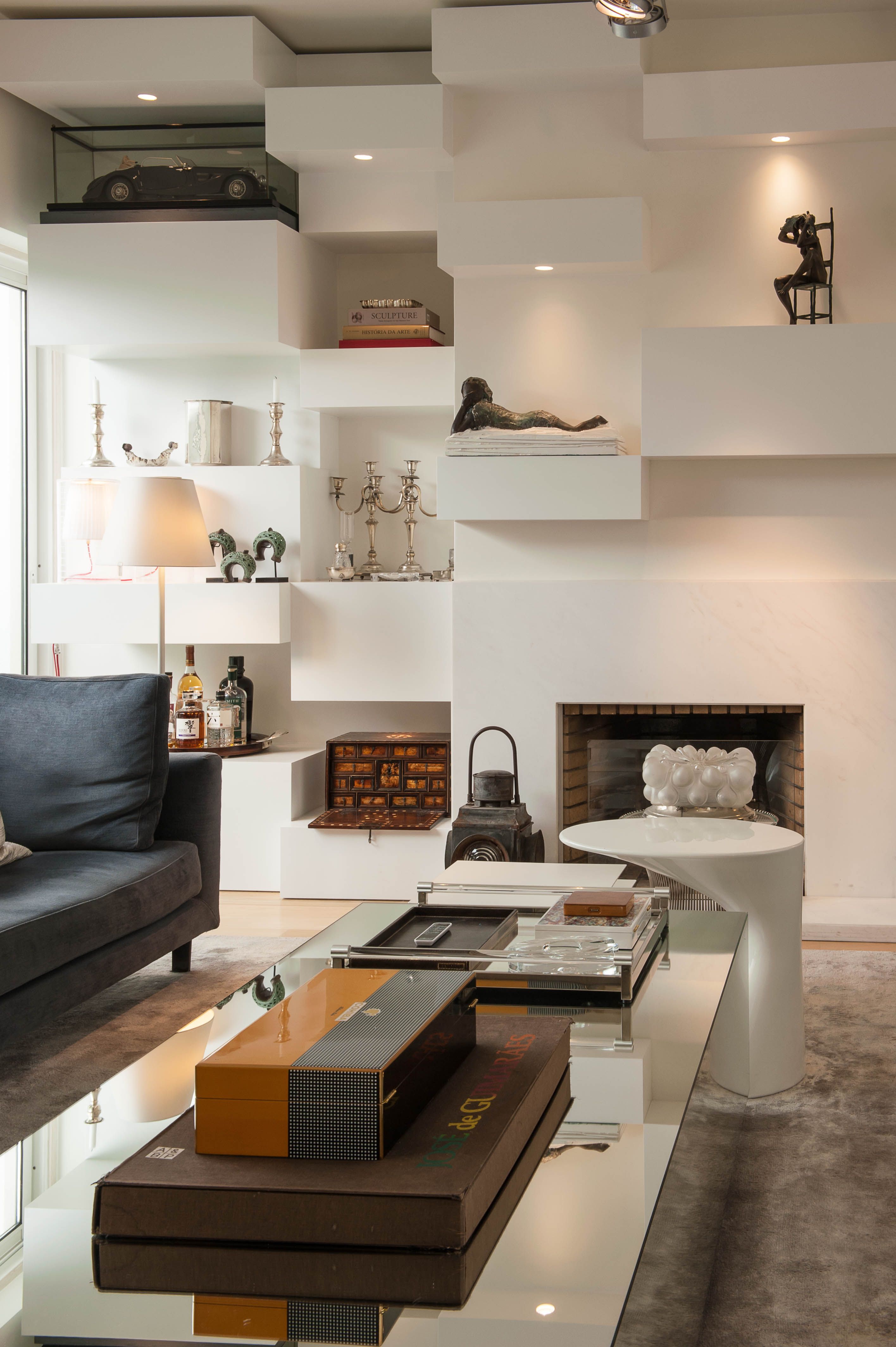 Living room with custom shelving and fireplace in a house renovation in Portugal
