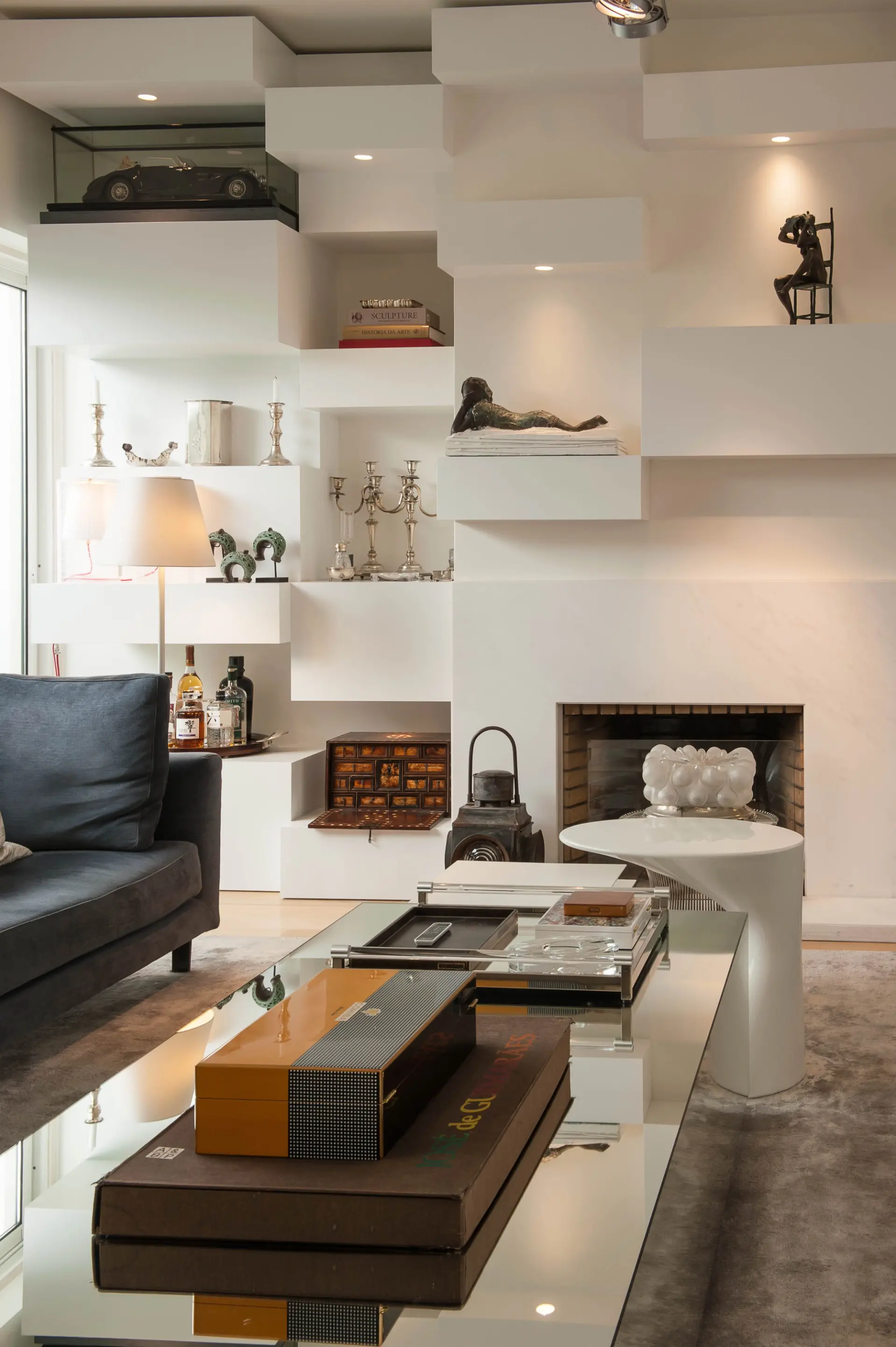 Living room with custom shelving and fireplace in a house renovation in Portugal