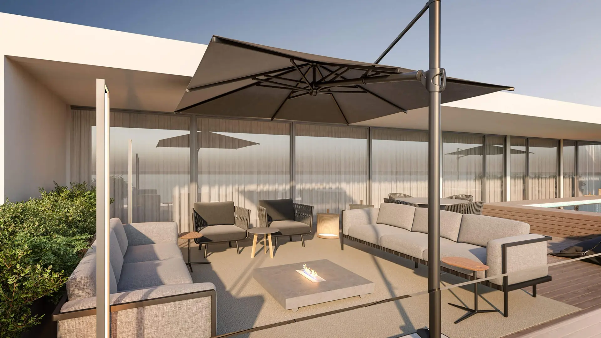 Outdoor lounge terrace with ethanol fire table, upholstered sofas and cantilever parasol — luxury interior design Lisbon