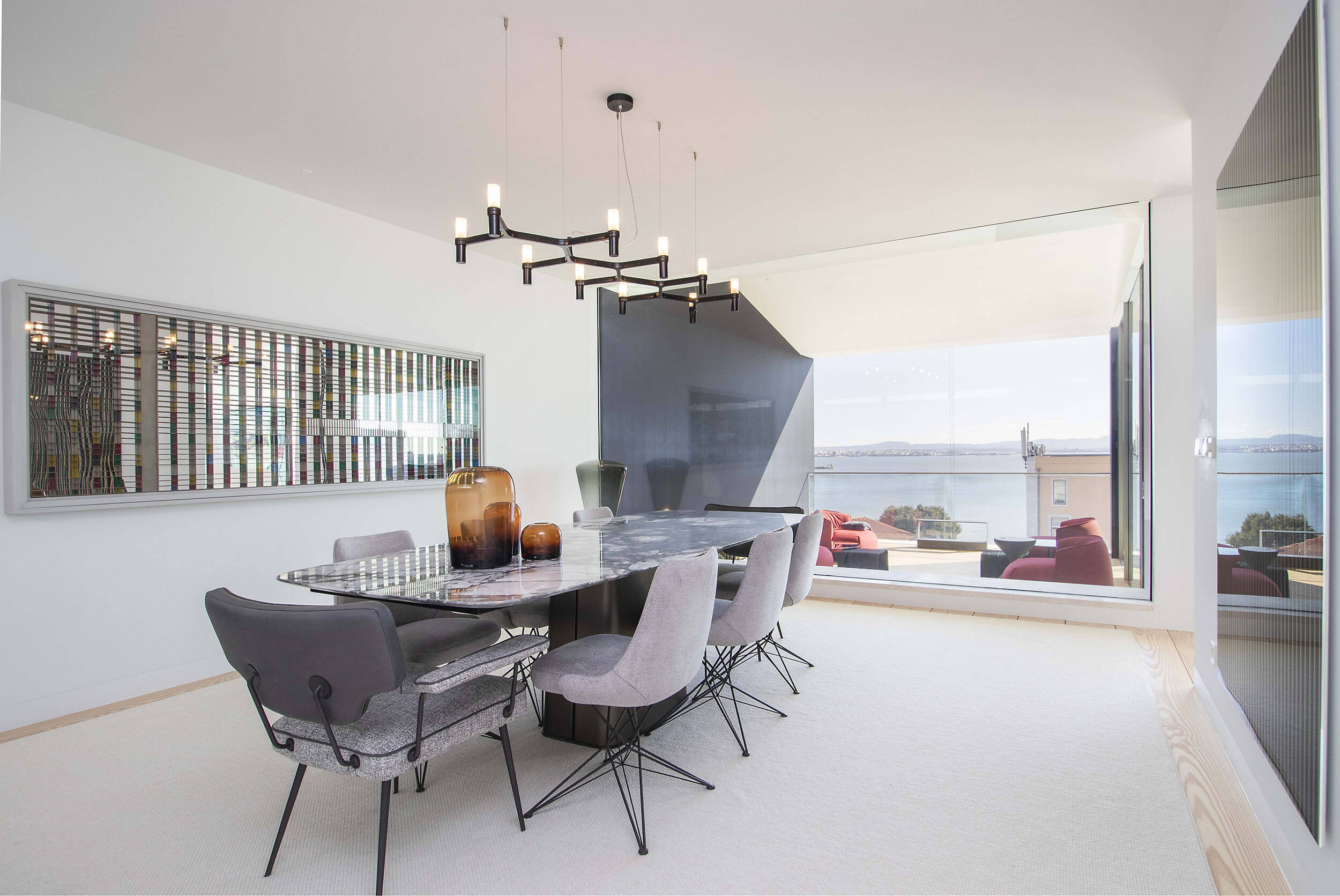 Dining room with Arketipo marble table and chairs, Rodrigo Oliveira artwork and Tagus River views — luxury interior design, Lisbon, Atelier Renata Santos Machado