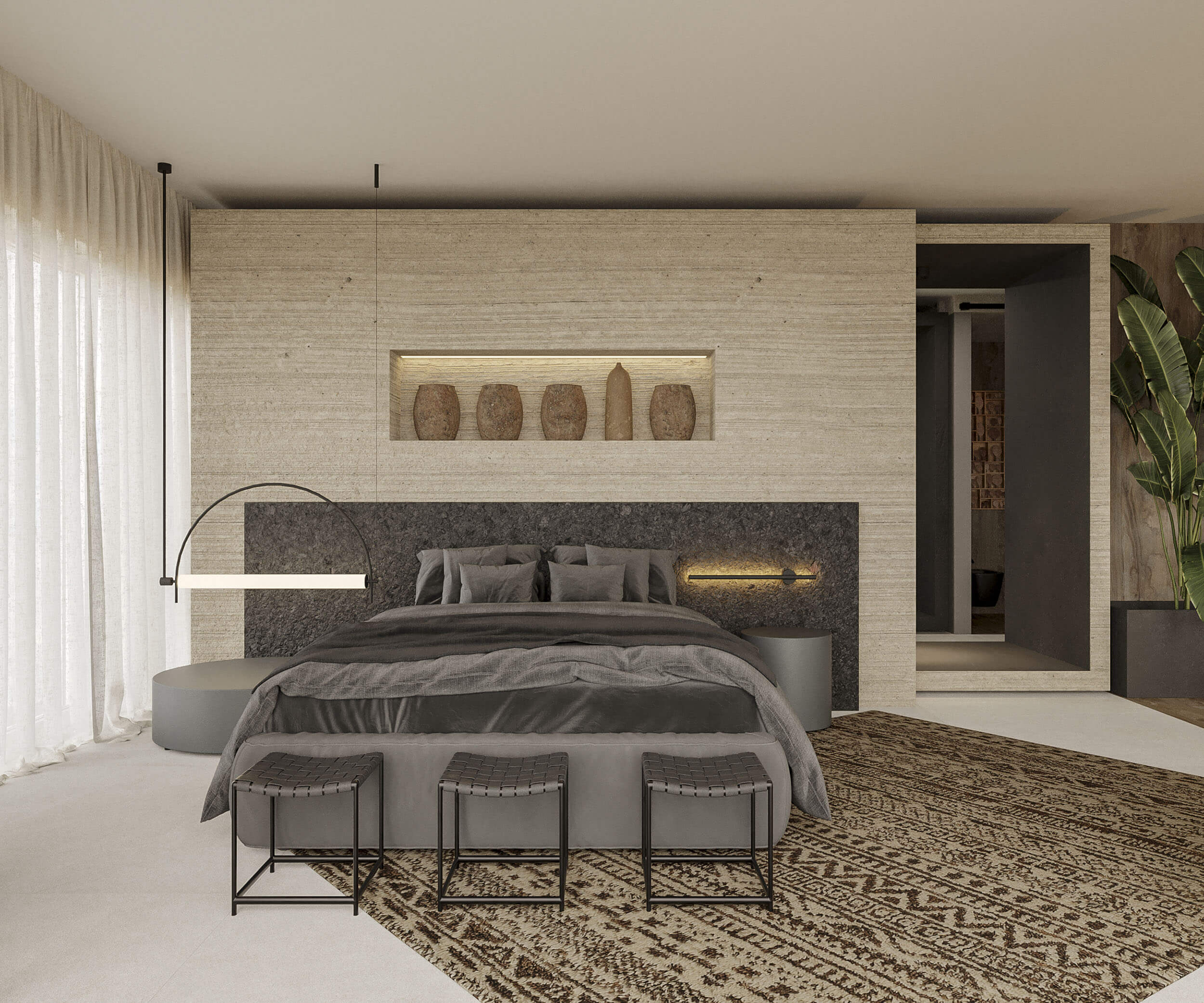 Basalt stone headboard below a travertine vessel niche with leather-strap stools and berber rug — luxury master suite design