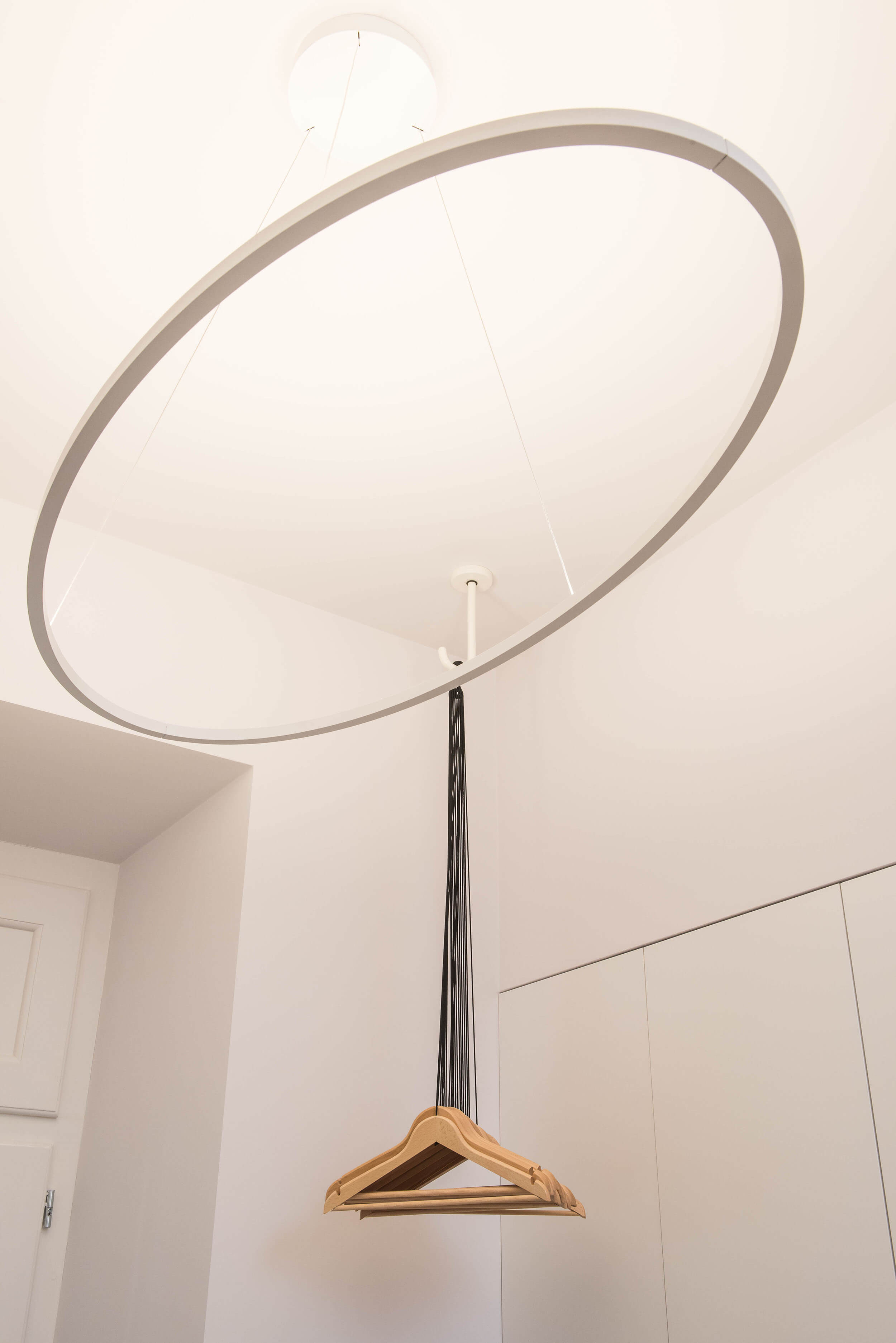 Hall detail with Nemo Ellisse Major circular pendant and Ligne Roset coat rack in Lisbon palace — luxury interior design, Atelier Renata Santos Machado