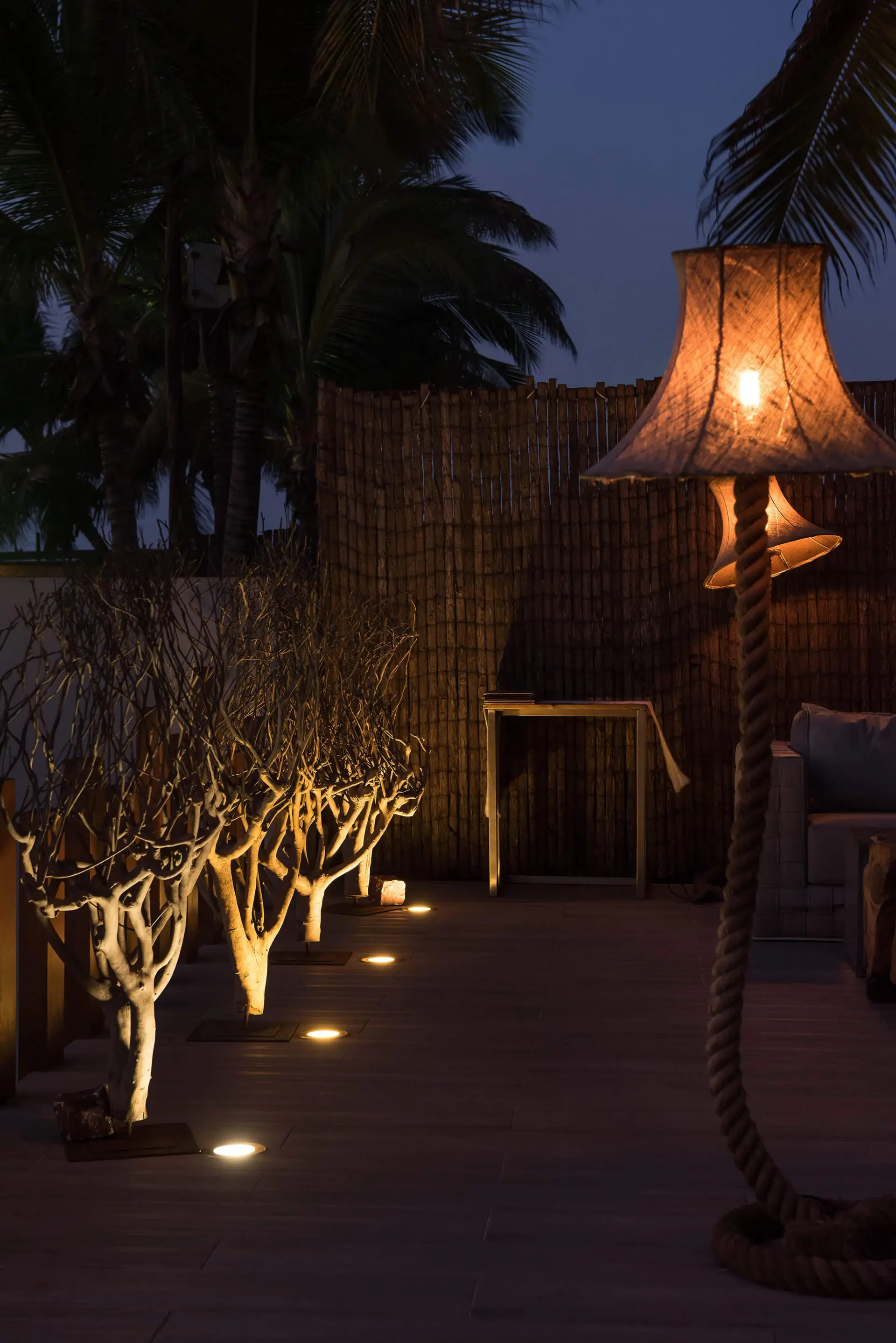 Candeeiro de pé com base em corda e árvores decorativas iluminadas — design de interiores de restaurante de luxo Luanda, Angola