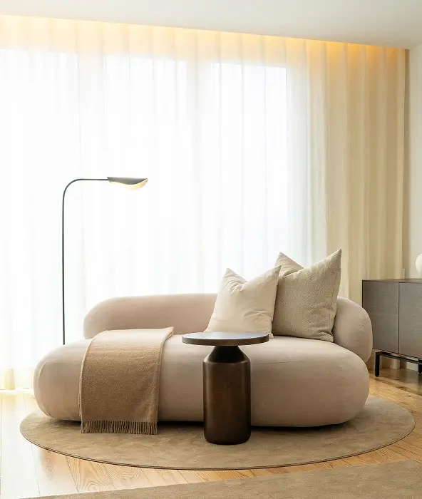 3D render of living room with curved bouclé sofa, bronze side table, round jute rug and floor lamp — luxury residential interior design in Lisbon, Atelier Renata Santos Machado