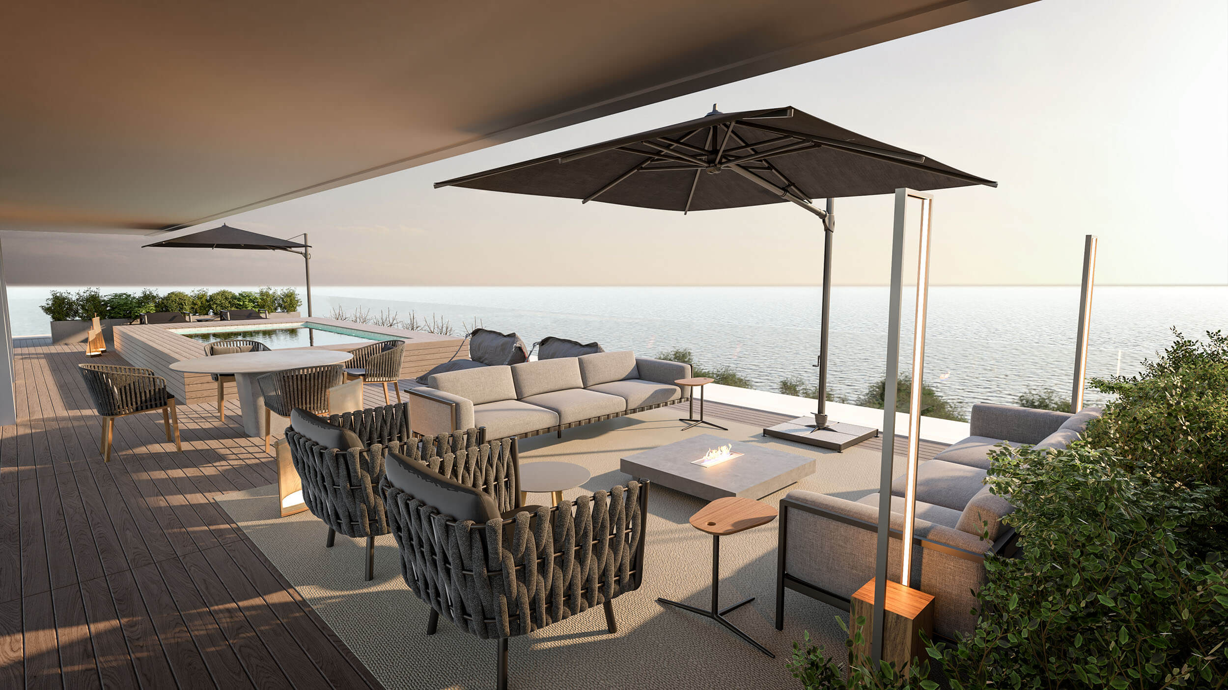Terraço exterior com vista para o mar, sofás e guarda-sol de braço e piscina ao fundo — design de interiores de luxo Lisboa