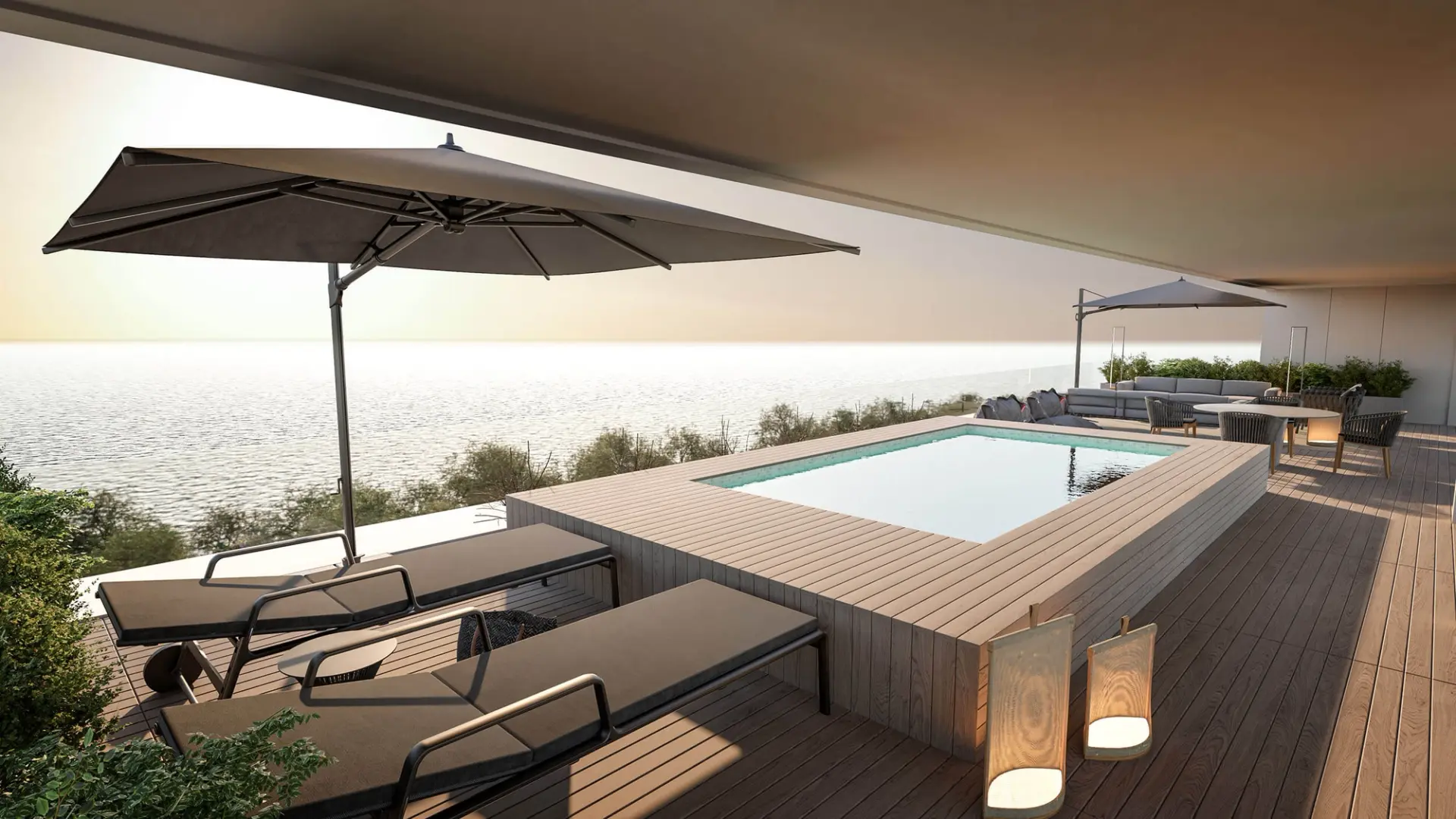 Elevated pool on wooden deck with sea view, black loungers and soft lighting