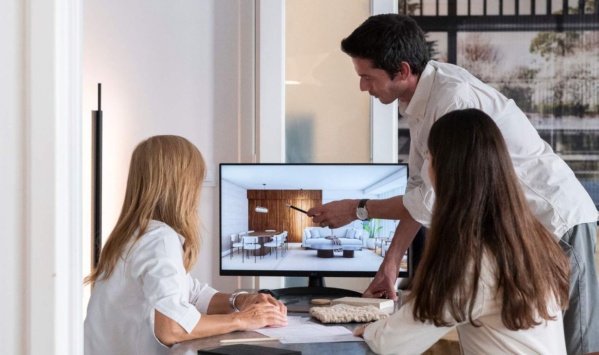 Interior designers in Portugal presenting a residential project to international clients, with 3D visualization, material samples and remote project coordination.