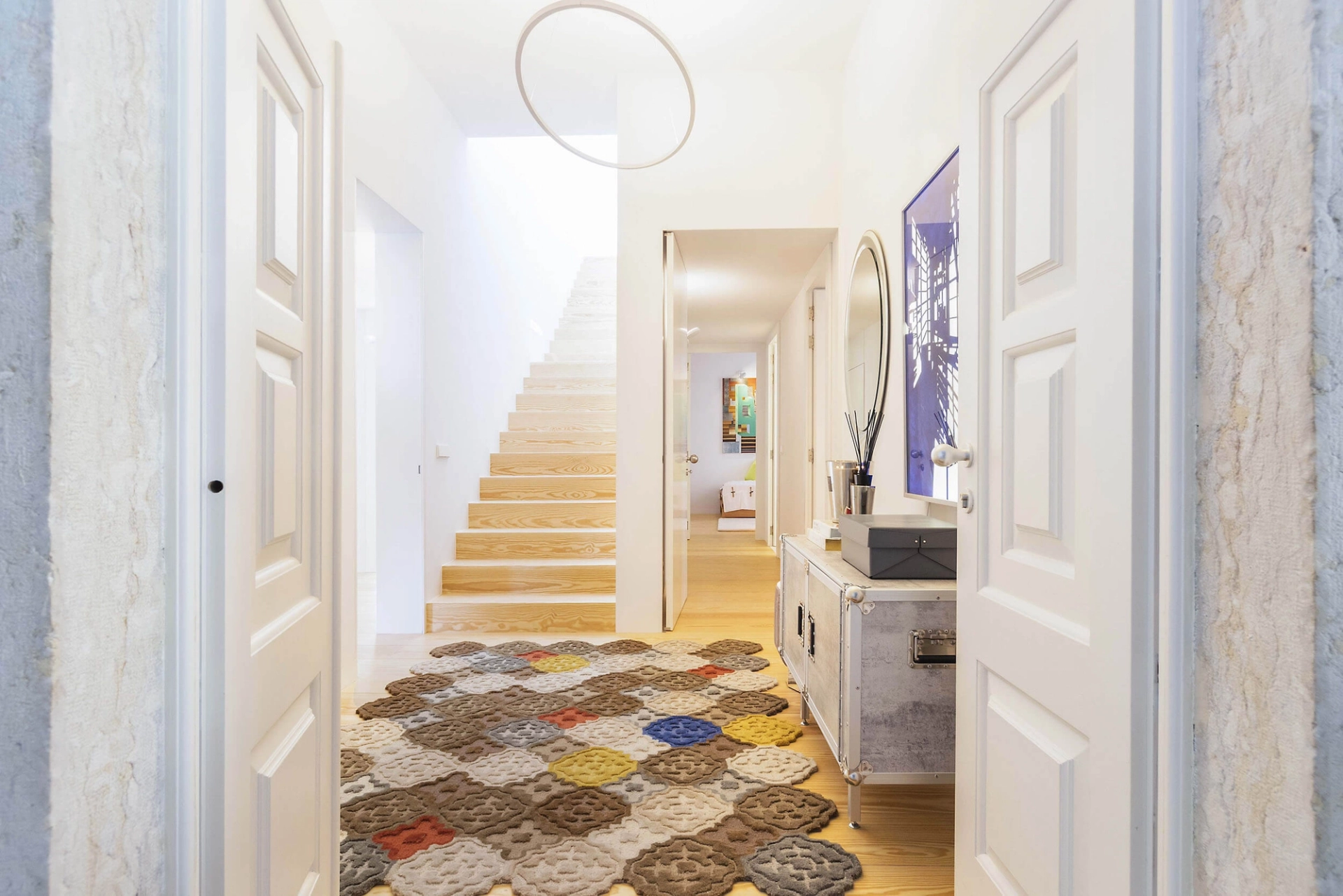 Entrance hall with Gandia Blasco hexagonal rug, Nemo circular pendant and palace staircase — luxury interior design, Lisbon, Atelier Renata Santos Machado