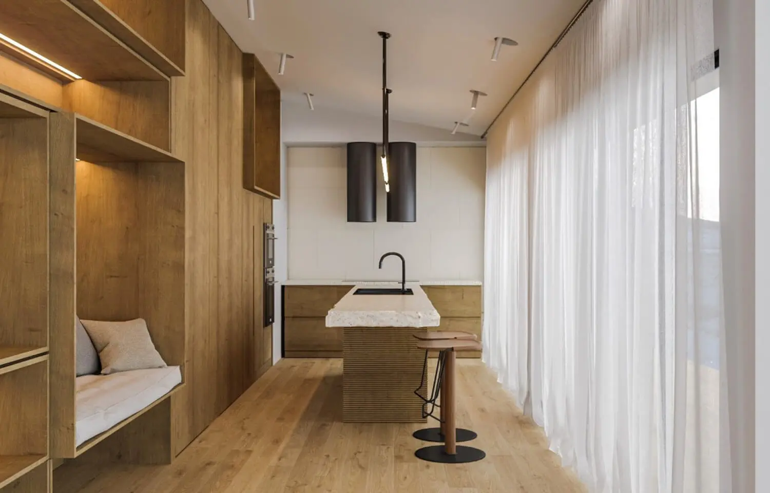 Kitchen in natural wood with a central island, organic white stone countertop, and suspended lighting.