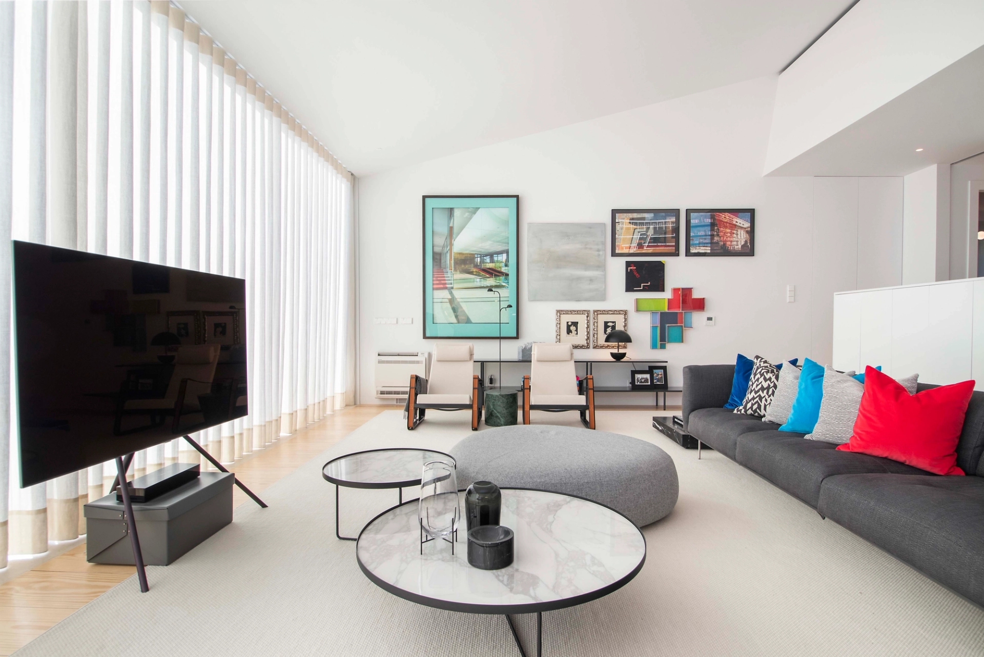 Contemporary living room with colourful artwork and modern furniture in an interior design project.