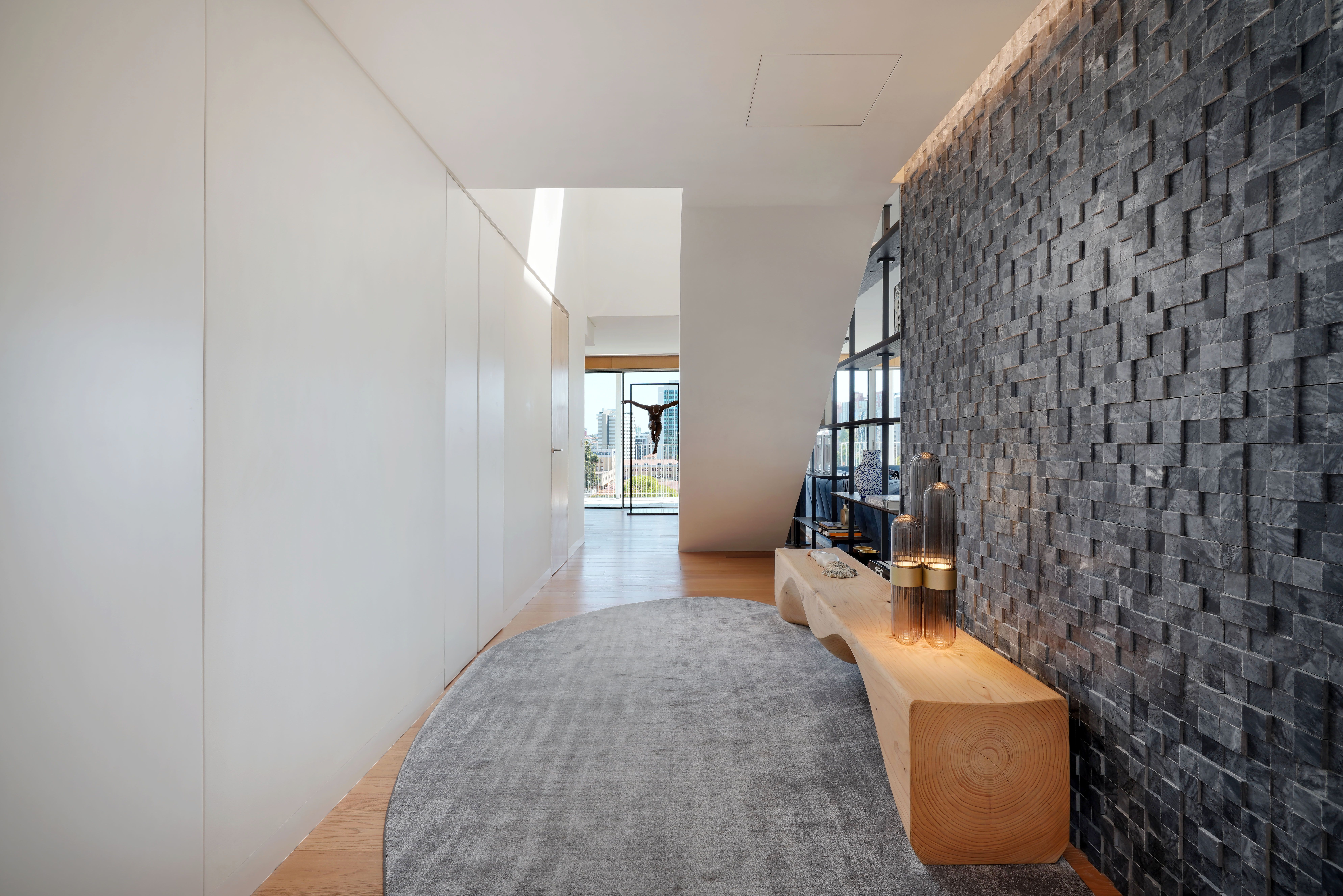 Contemporary entrance hall with textured stone wall in a renovated property in Portugal