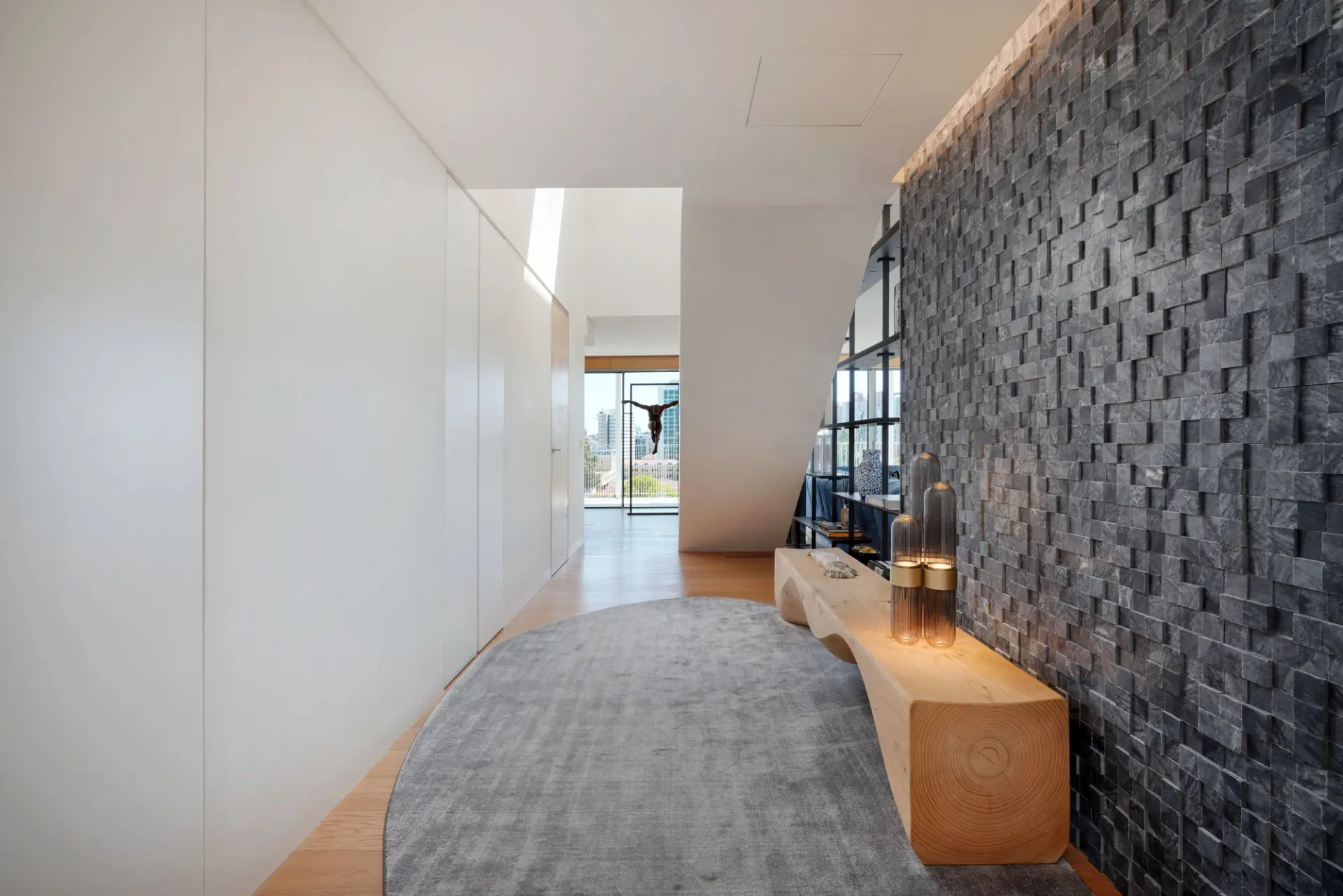 Contemporary entrance hall with textured stone wall in a renovated property in Portugal