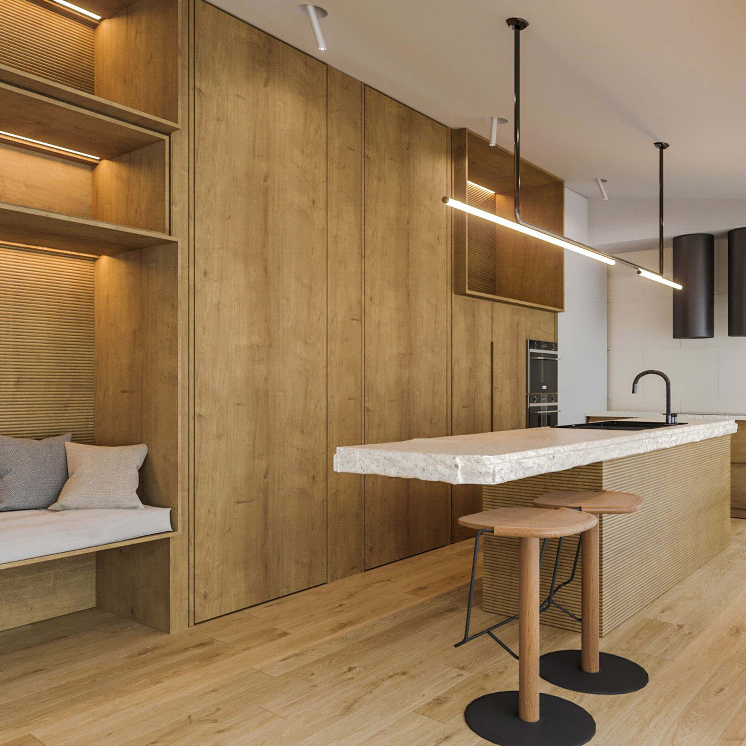 Fluted oak island with a terrazzo top, a linear pendant and wood tripod stools beside a reading nook — luxury kitchen