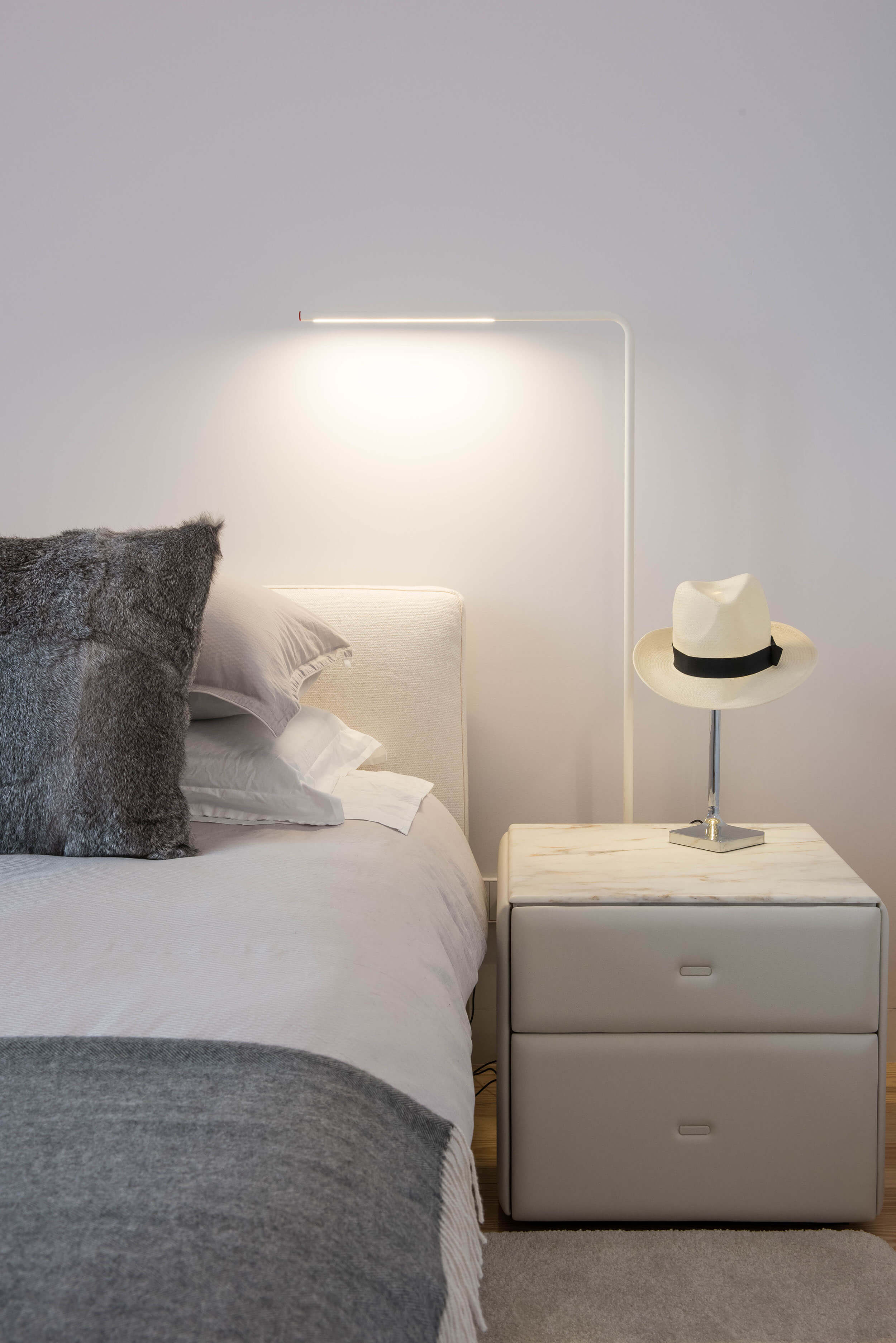 Suite bedside detail with Poltrona Frau Moondance in Calacatta Oro marble and FLOS Chapô table lamp — luxury interior design, Lisbon, Atelier Renata Santos Machado
