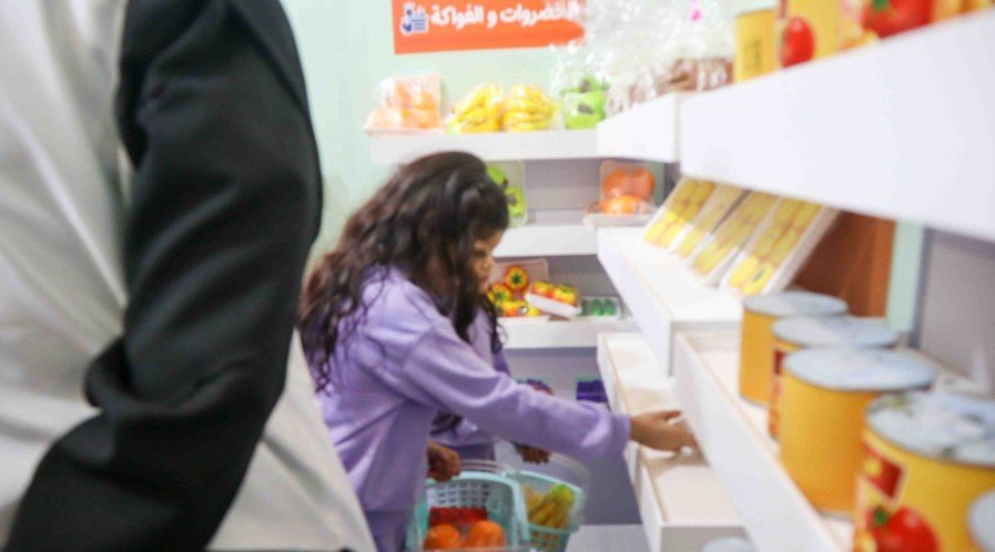 A child choosing food products in the interactive supermarket experience