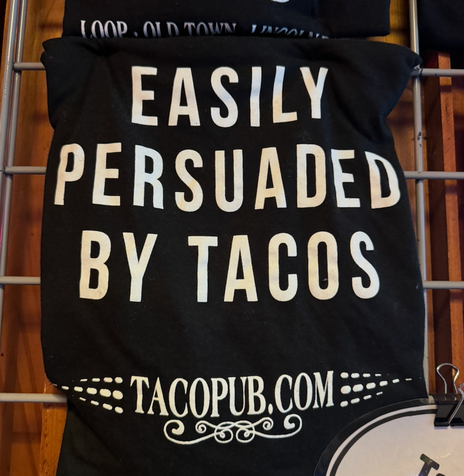 A t-shirt with the text Easily Persuade By Tacos