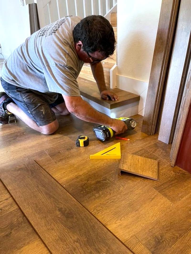 Lindcol installer wrapping a stair step in vinyl