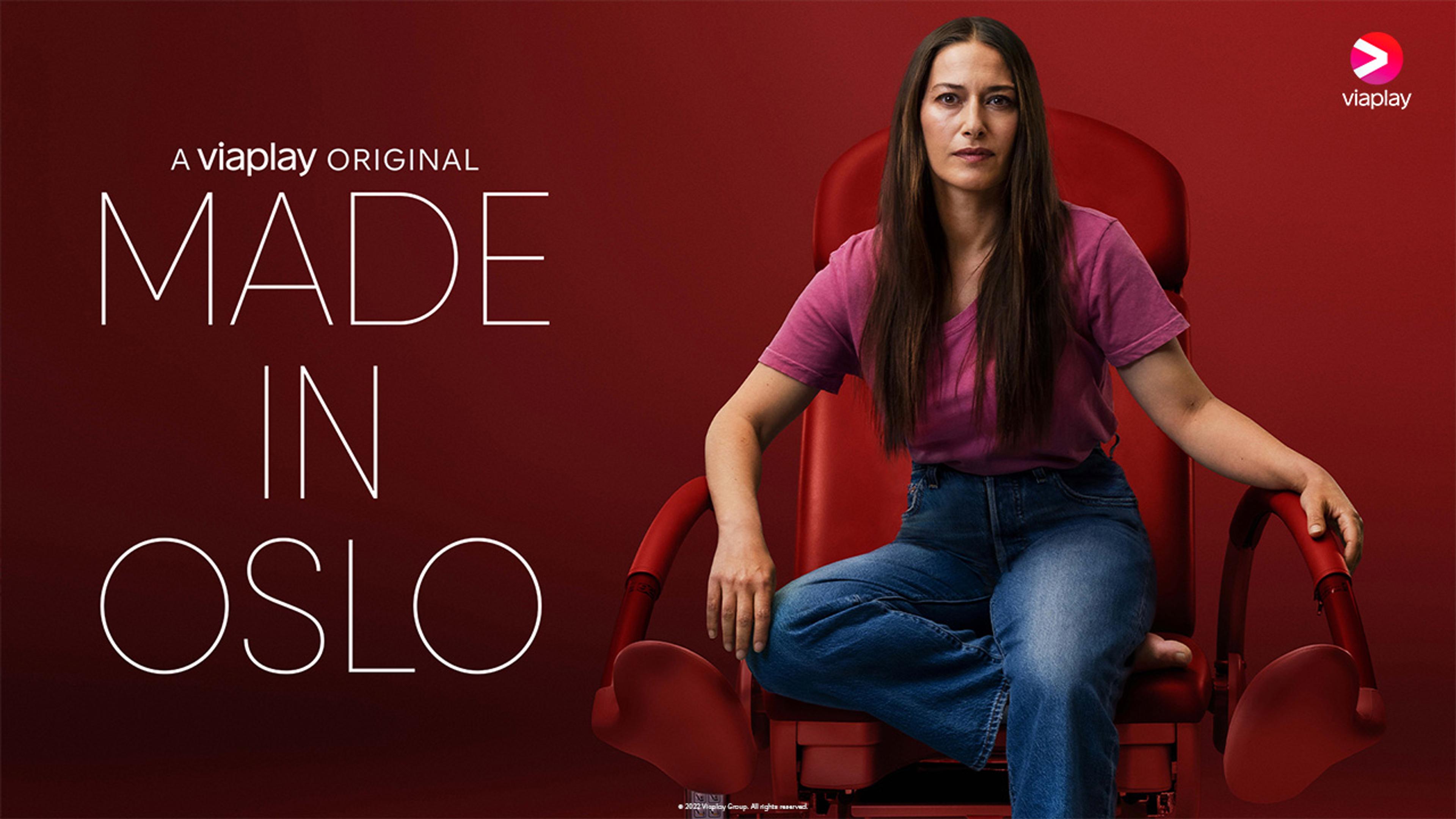 Dame med langt hår sitter i rød stol i et rødt rom.