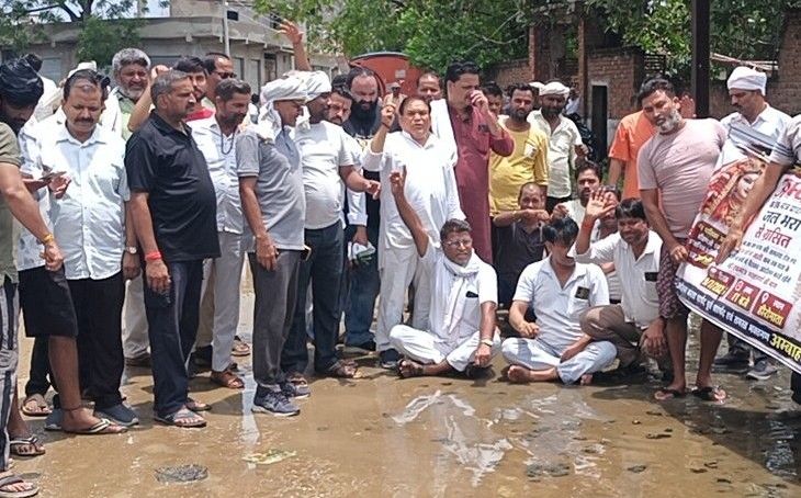 अंबाह के हीरो माता मंदिर में जलभराव पर फूटा आक्रोश, विधायक समेत सैकड़ों श्रद्धालु नाली में बैठे