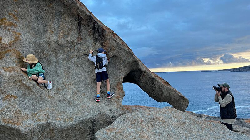Fuller crew member photographing talent beside Remarkable Rocks on Kangaroo Island.