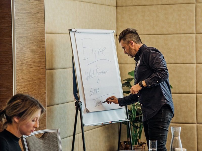 Will Fuller writing on paper at the Eyre brand workshop