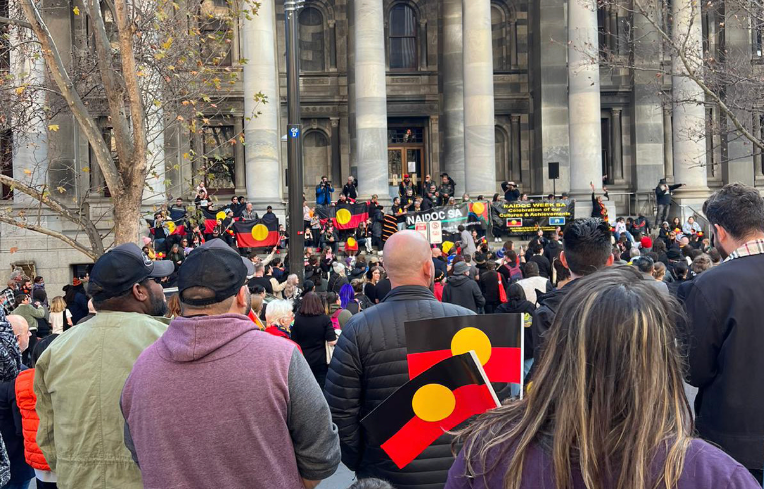 people marching at Naidoc week in front of parliament house