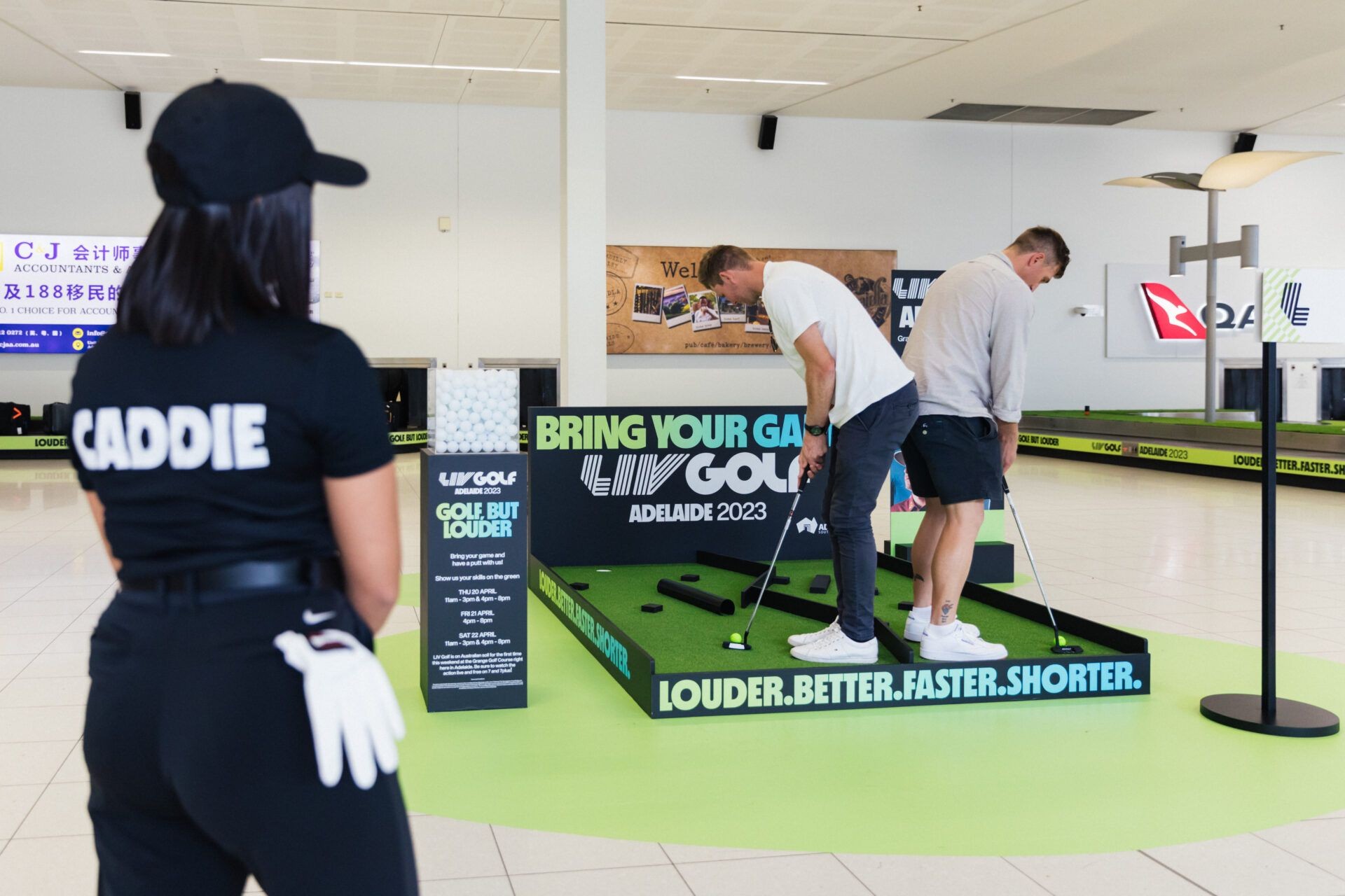 People playing put put in the airport for Liv golf