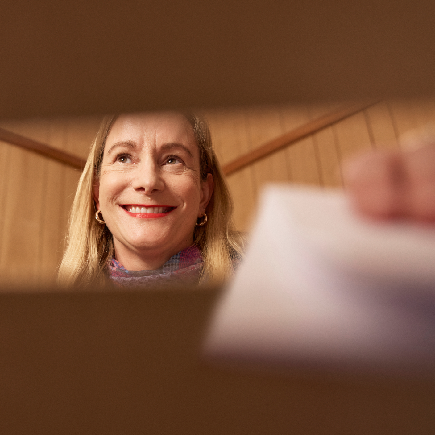 a person placing their vote into a box