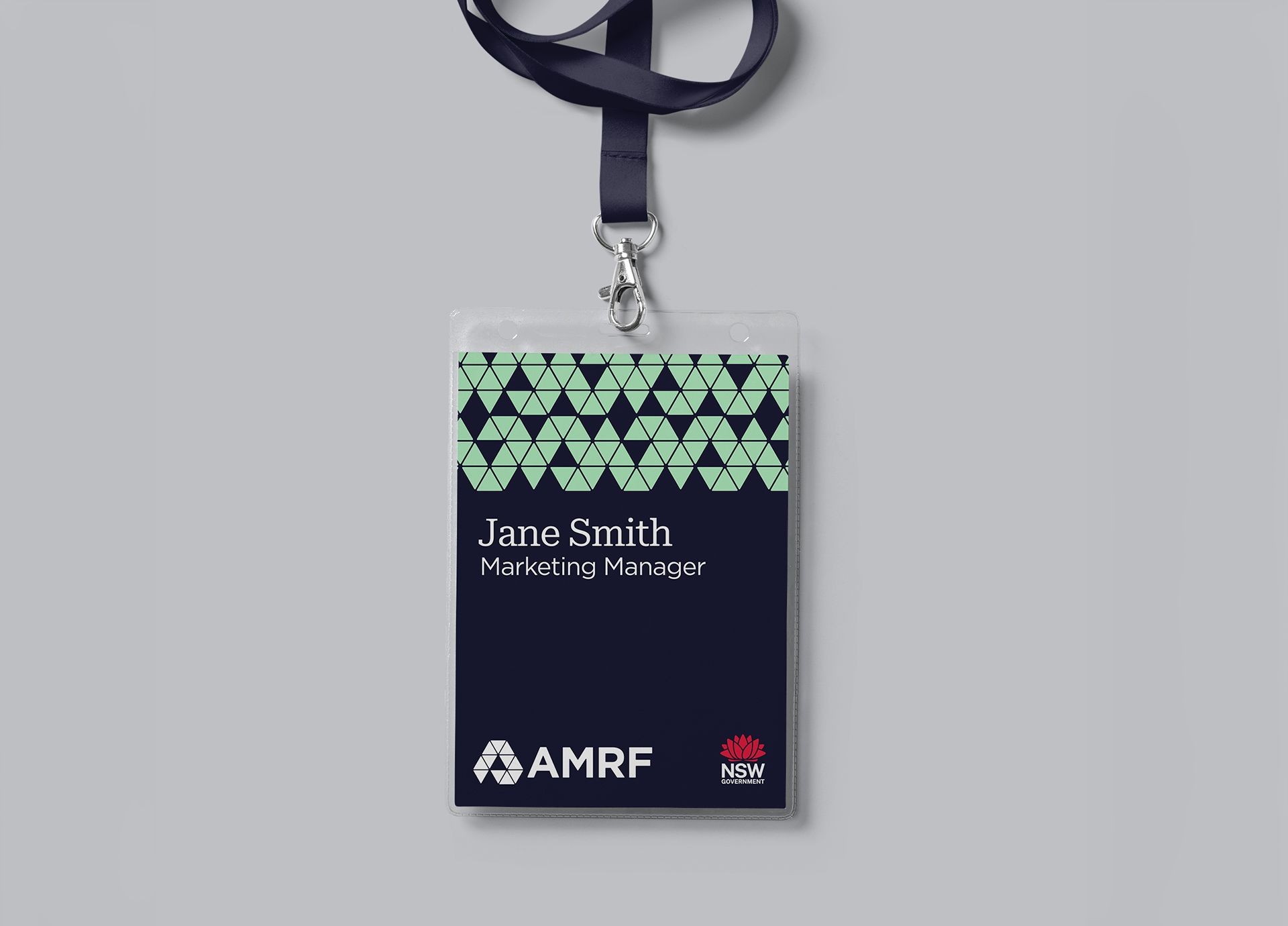 AMRF staff lanyard and name badge featuring the green and navy brand identity.