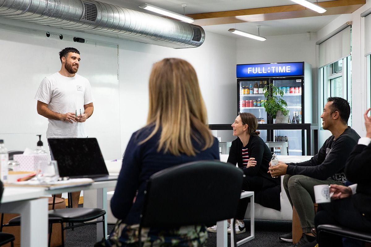 A group of people in an open room talking