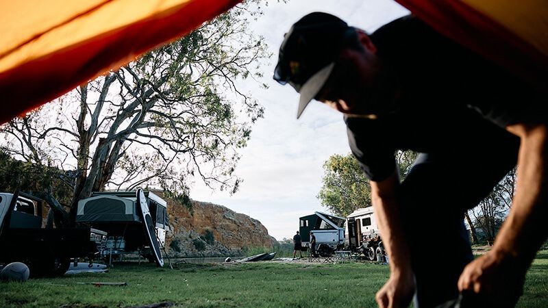 A person looking inside a tent