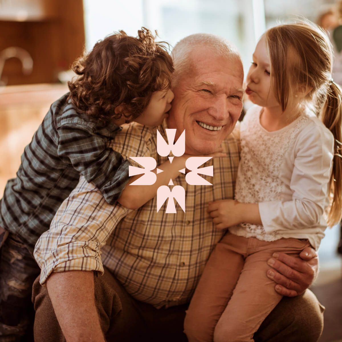 An older person with a child on his lap and another child on his back