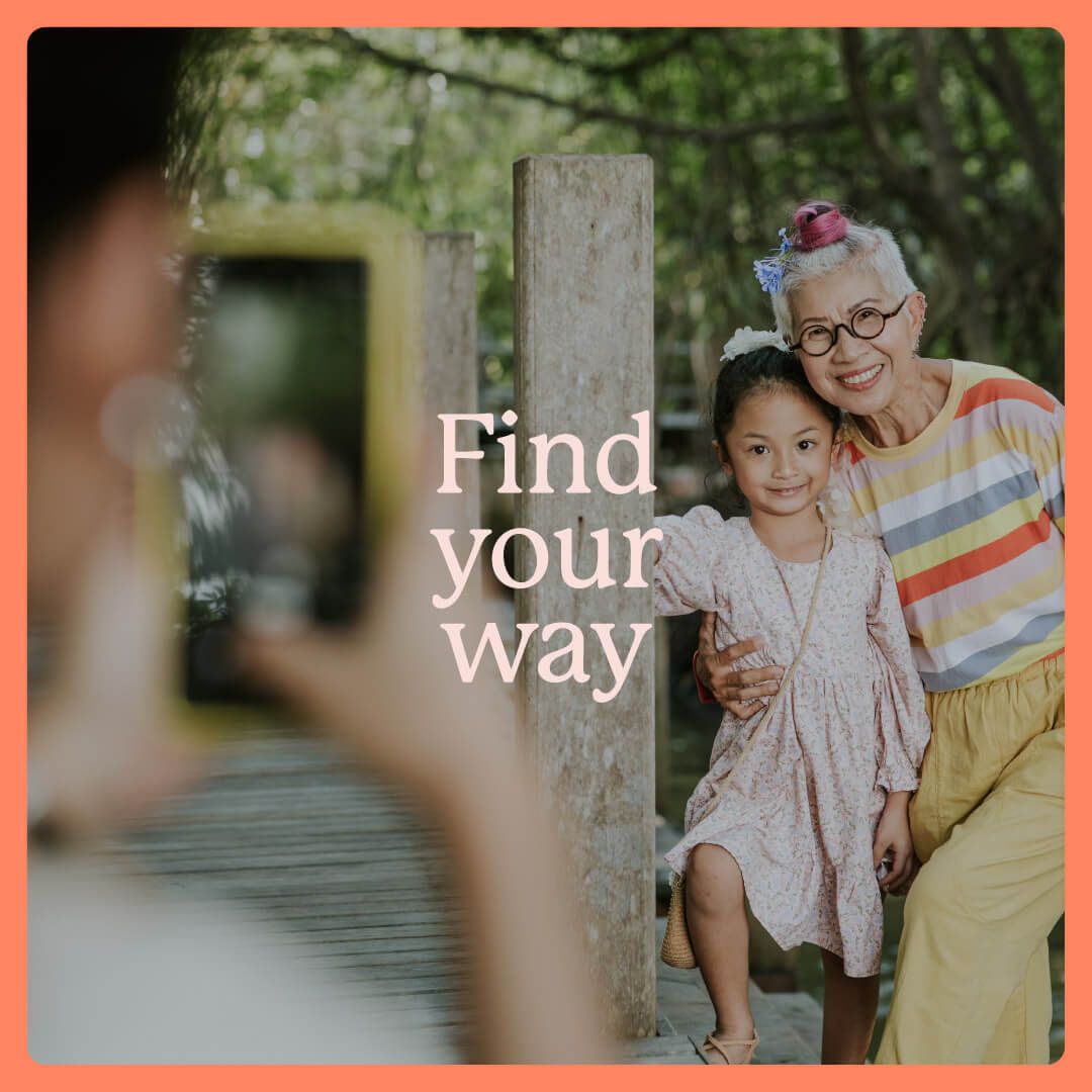 A person taking a photo on their mobile of an older person and a child