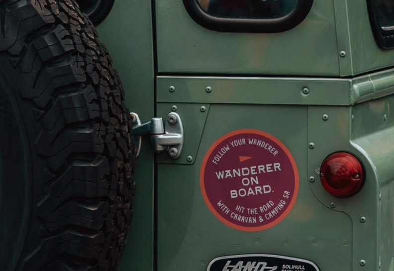 The Follow your wanderer campaign sticker on the back of a green land rover