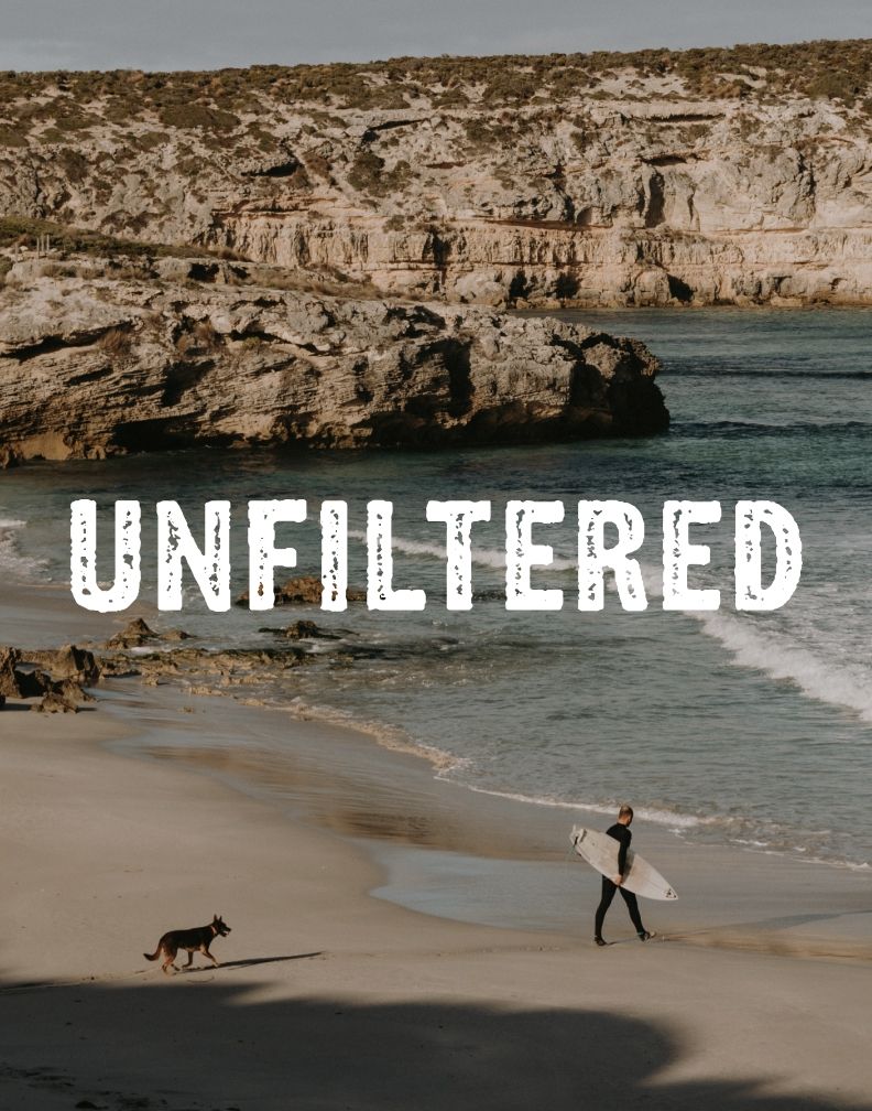 Kangaroo Island “Unfiltered” campaign hero artwork featuring a surfer and dog walking along a remote beach.