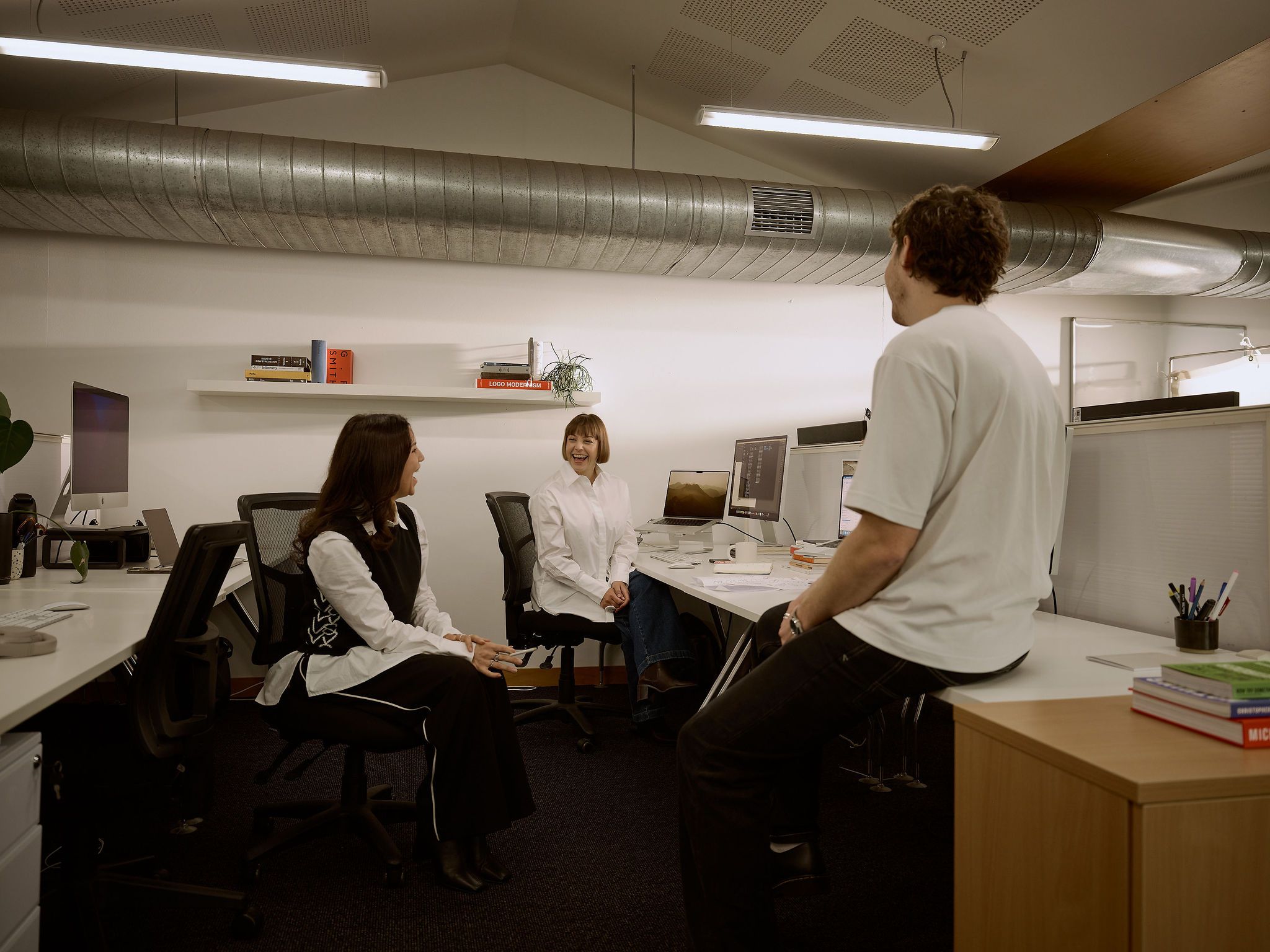The design team at Fuller talking at their desks